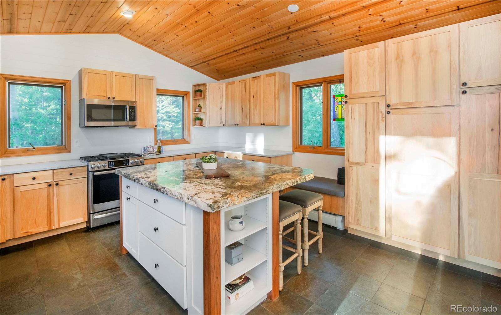 13416 Kuehster Road Littleton, CO 80127 - Photo 16 of 50 a kitchen with a stove a sink a refrigerator and a window