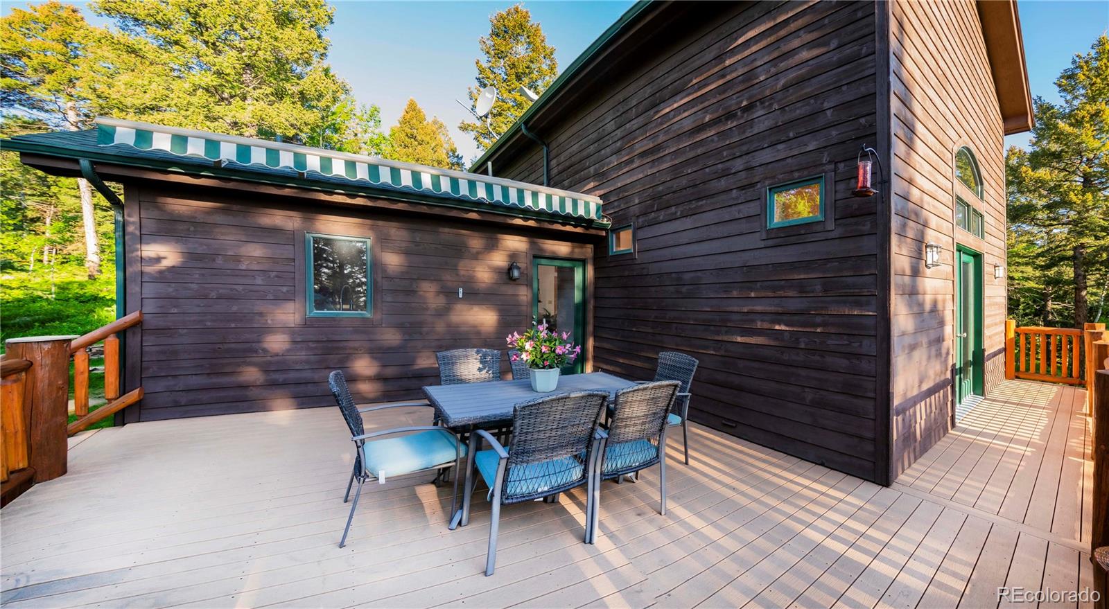 13416 Kuehster Road Littleton, CO 80127 - Photo 20 of 50 a backyard of a house with wooden floor table and chairs