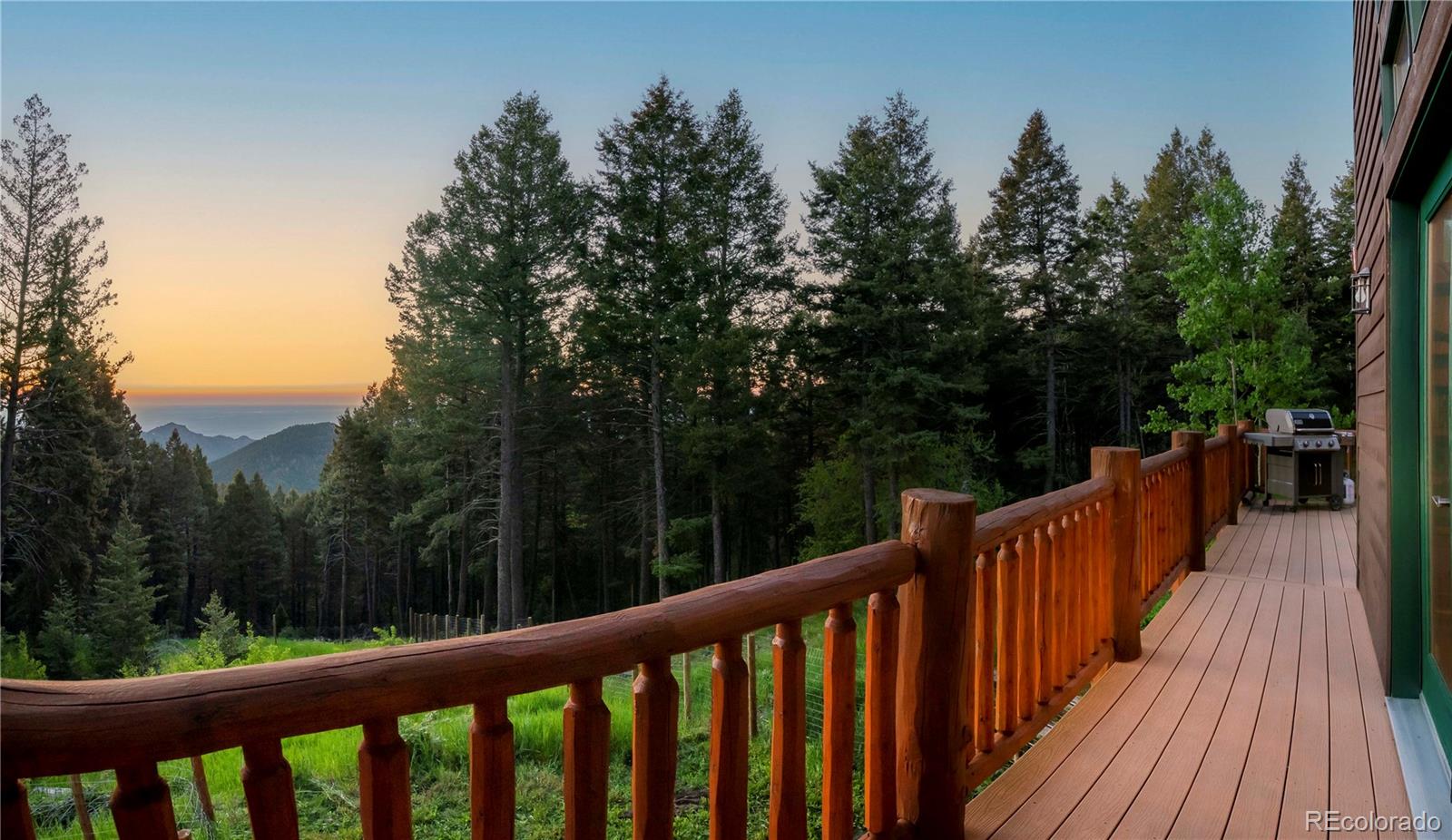 13416 Kuehster Road Littleton, CO 80127 - Photo 21 of 50 a balcony with wooden floor and trees in the background