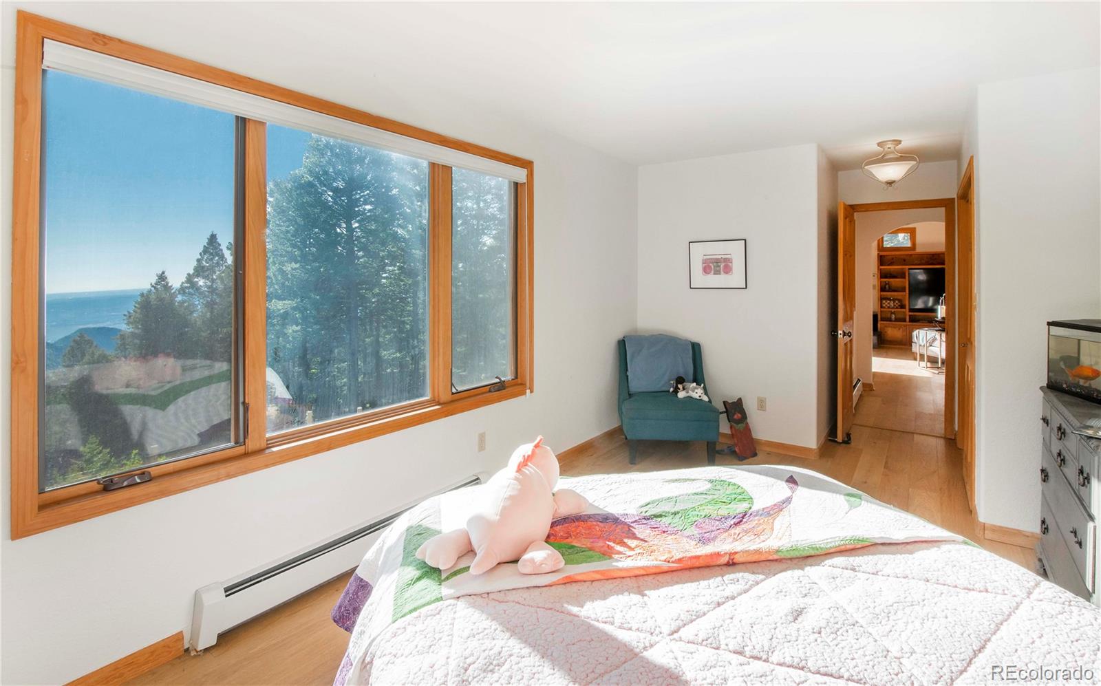 13416 Kuehster Road Littleton, CO 80127 - Photo 23 of 50 a bedroom with a bed and wooden floor