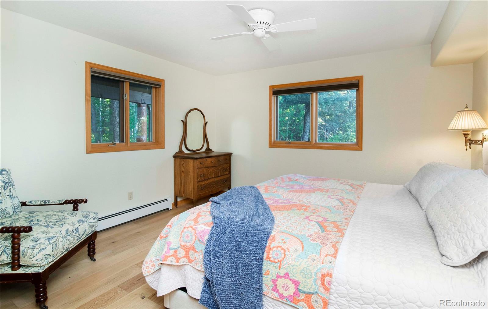13416 Kuehster Road Littleton, CO 80127 - Photo 25 of 50 a bedroom with a bed and a lamp