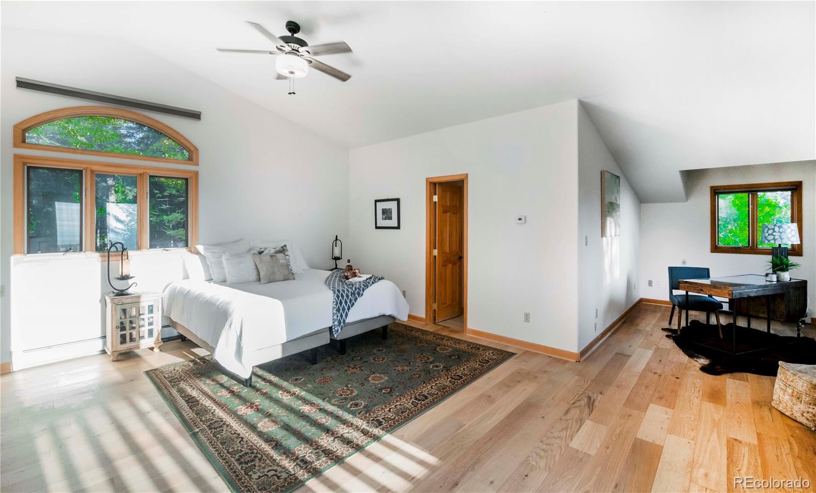 13416 Kuehster Road Littleton, CO 80127 - Photo 29 of 50 a bed room with a bed and a chandelier