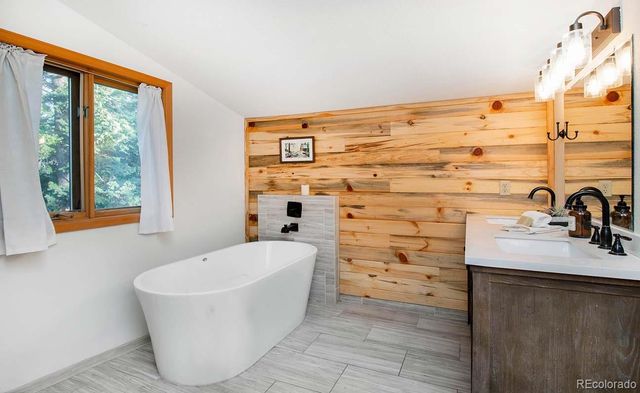 a bathroom with a bathtub and sink