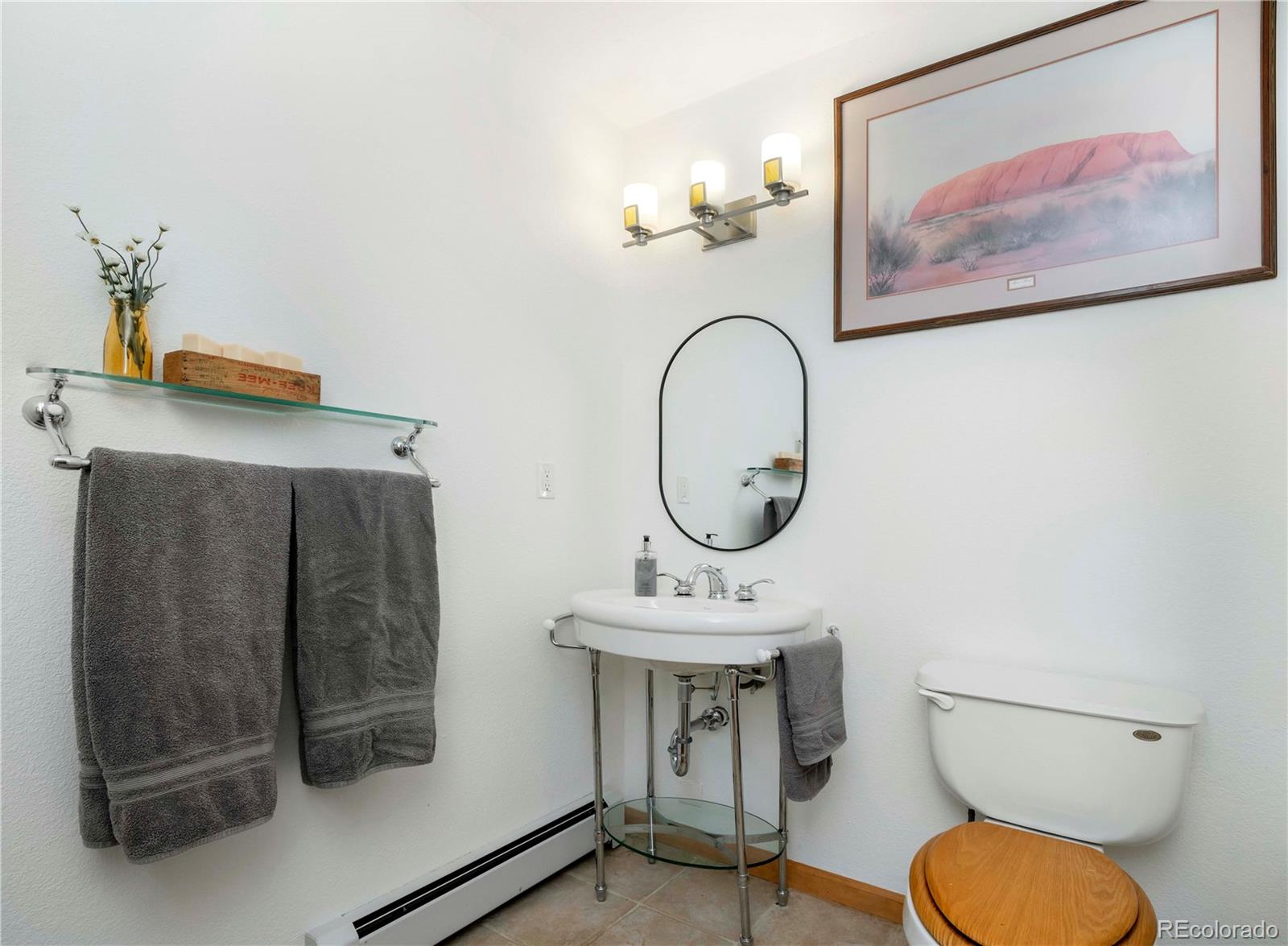 13416 Kuehster Road Littleton, CO 80127 - Photo 37 of 50 a bathroom with a toilet a sink and mirror