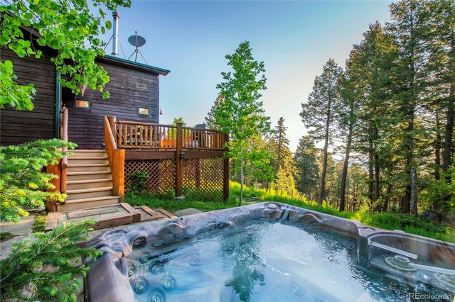 a view of a street with potted plants and brick walls