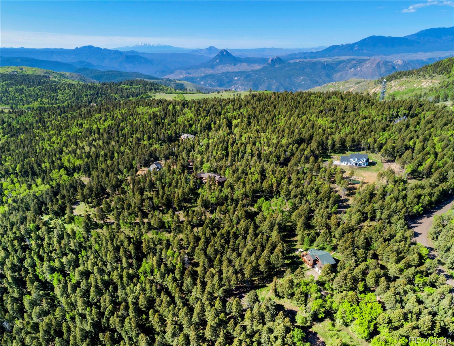 13416 Kuehster Road Littleton, CO 80127 - Photo 45 of 50 a view of a lush green field with a mountain in the background