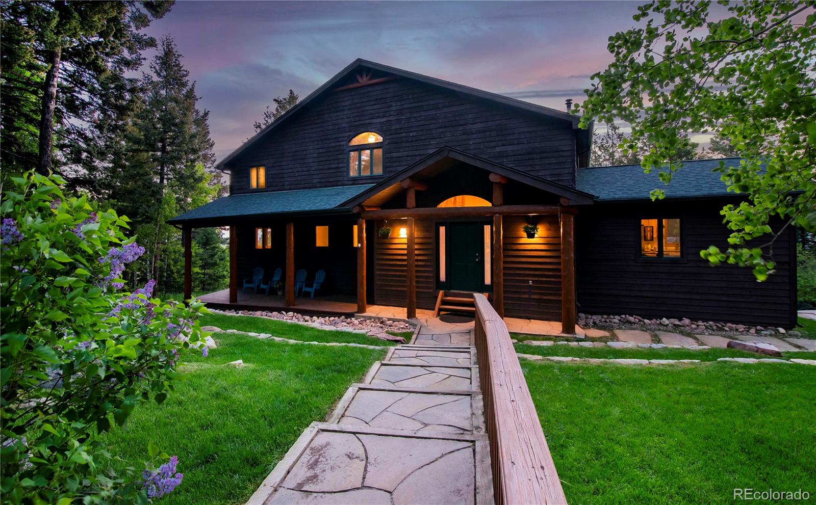 13416 Kuehster Road Littleton, CO 80127 - Photo 5 of 50 a front view of a house with a yard