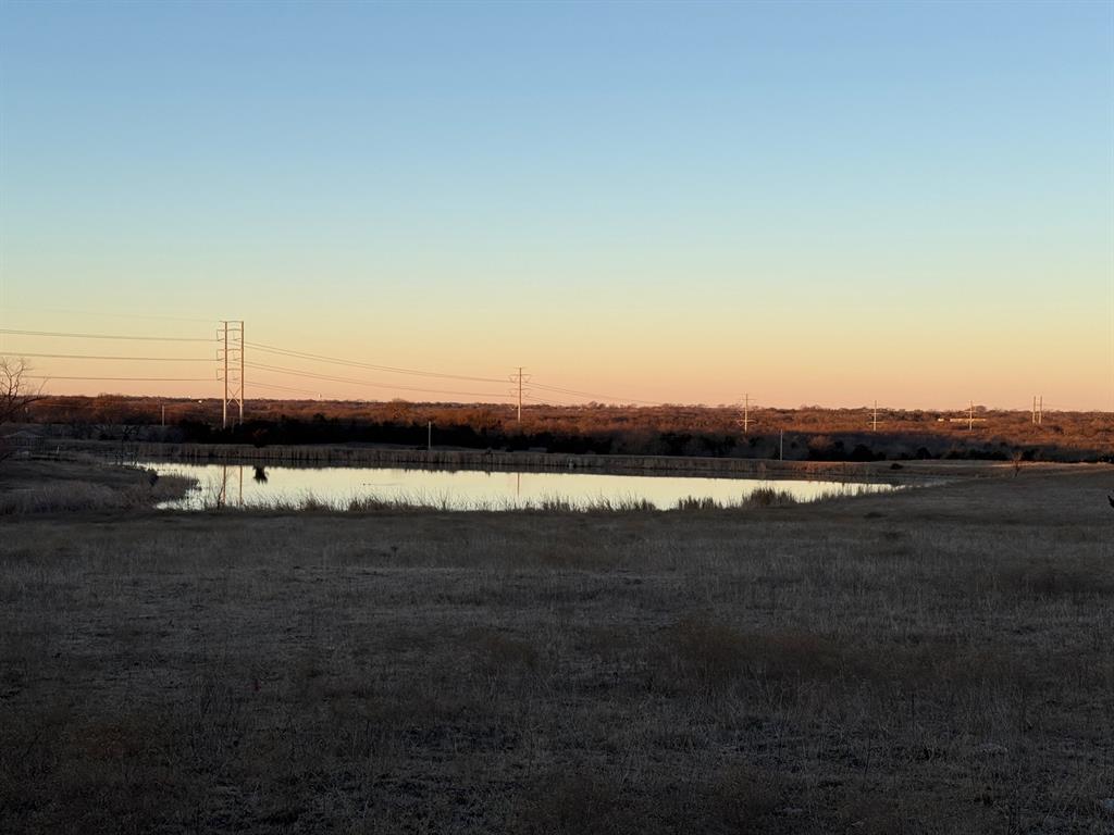 7933 South State Highway 78 Blue Ridge, TX 75424 - Photo 19 of 24 a view of a lake in middle of sunset