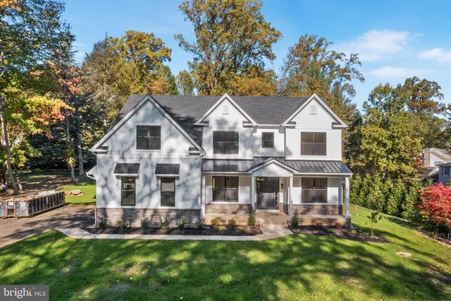 a front view of a house with a yard table and chairs