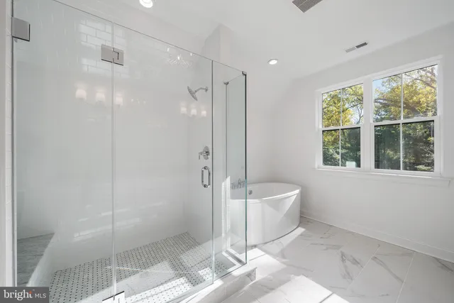 a spacious bathroom with a shower and a bathtub