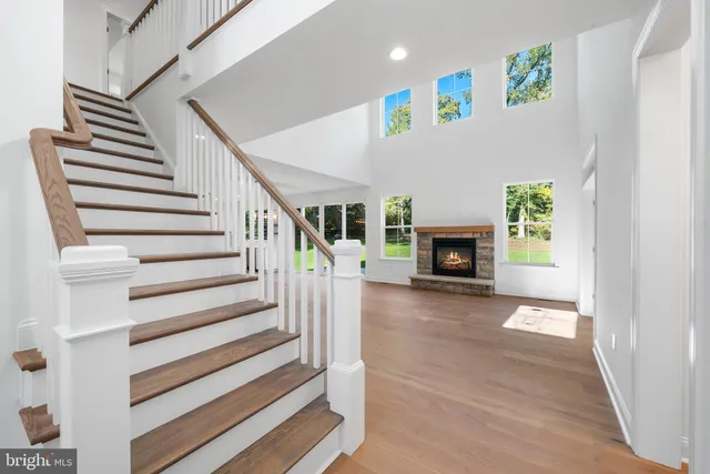 a view of a livingroom with wooden floor and a fireplace