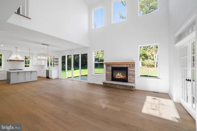 a view of an empty room with a fireplace and a window