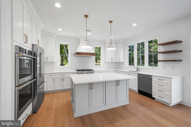 a kitchen with a sink stainless steel appliances and cabinets