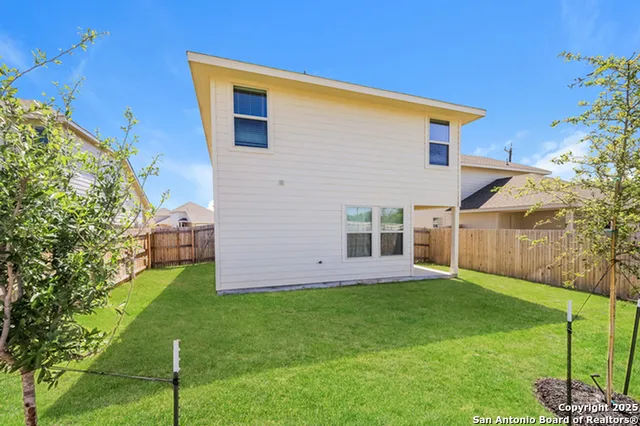 a kitchen with a sink and a stove top oven with wooden floor