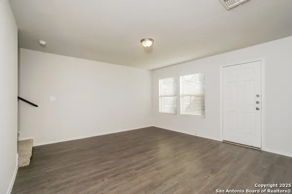 a view of a room with wooden floor