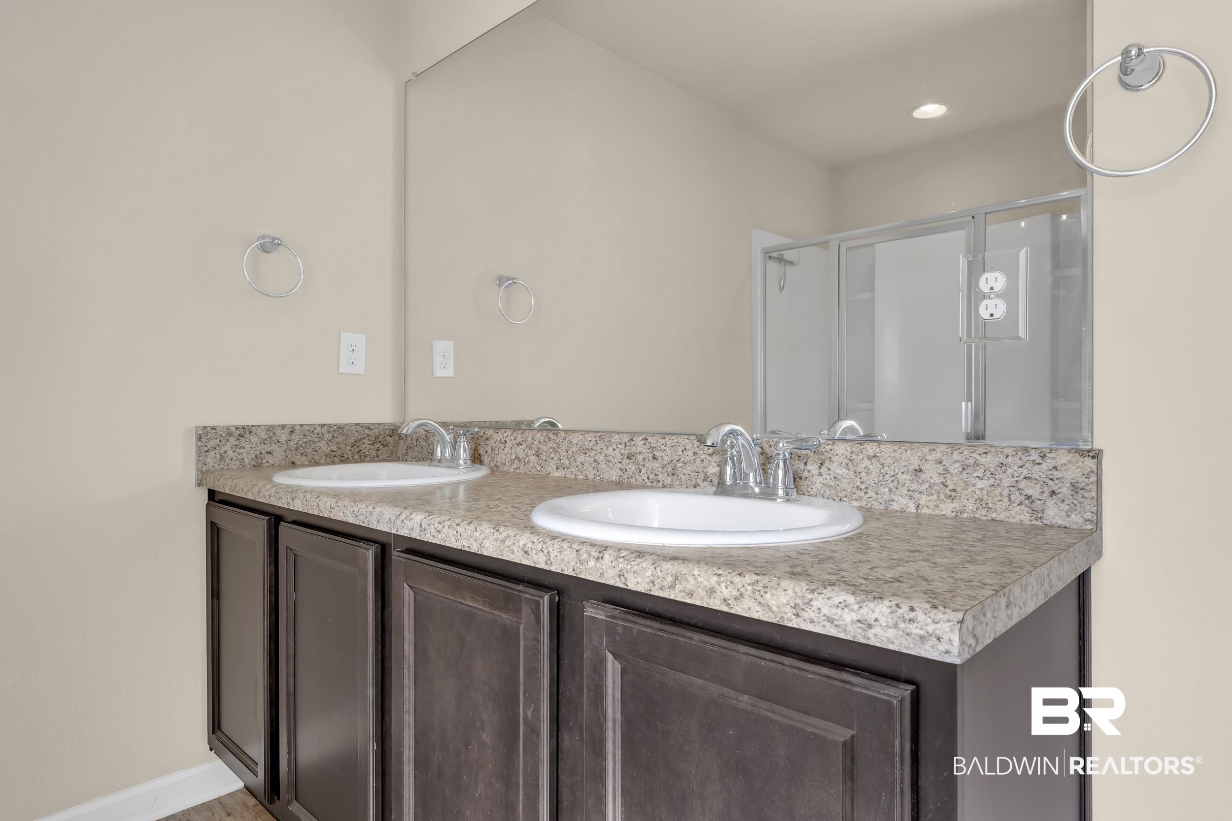 17344 Harding Drive Foley, AL 36535 - Photo 18 of 46 Double vanity featuring dark wood cabinetry and a speckled countertop