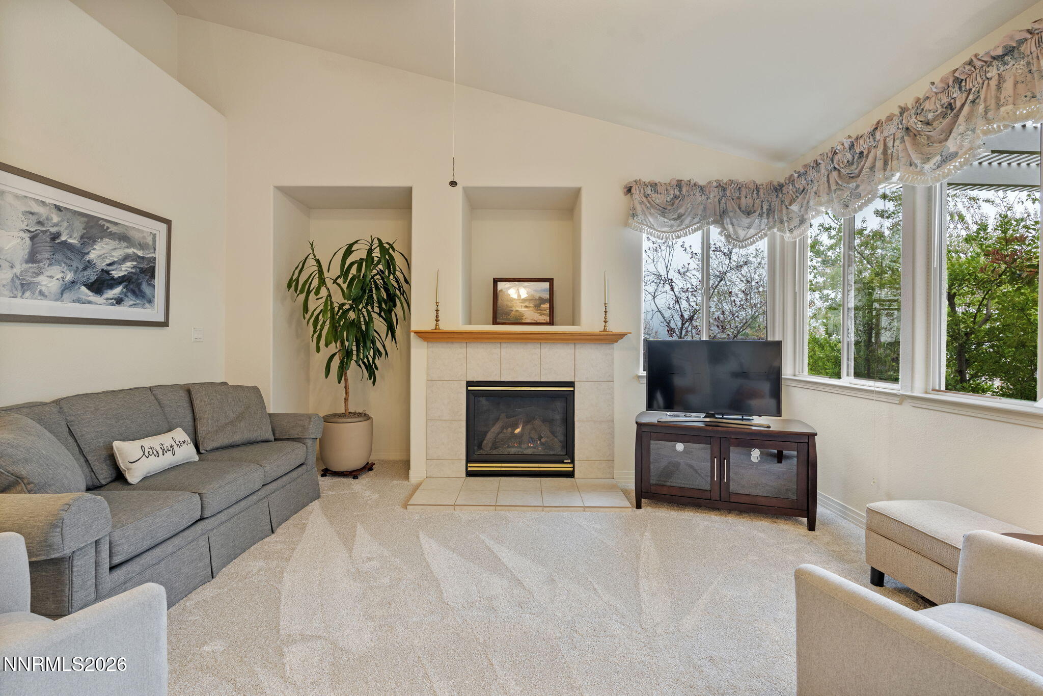 2741 Sunline Drive Reno, NV 89523 - Photo 25 of 47 a living room with furniture a fireplace and a large window