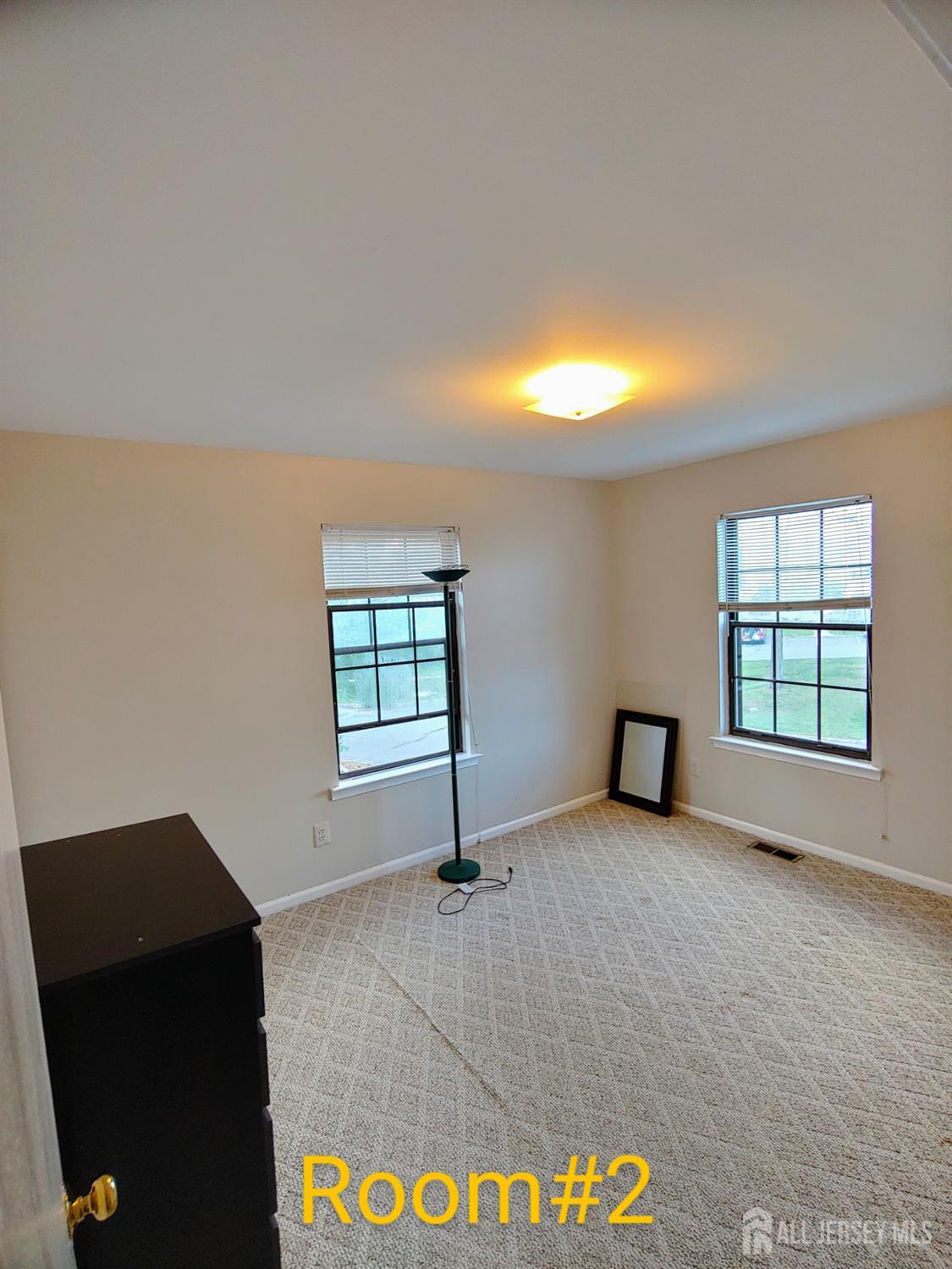 3305 Stonehedge Road Edison, NJ 08820 - Photo 11 of 16 an empty room with windows