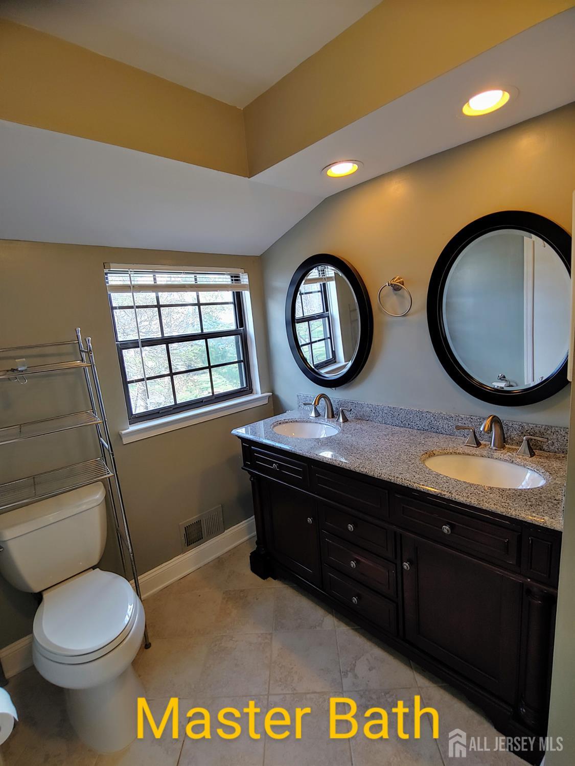 3305 Stonehedge Road Edison, NJ 08820 - Photo 12 of 16 a bathroom with double vanity and a toilet