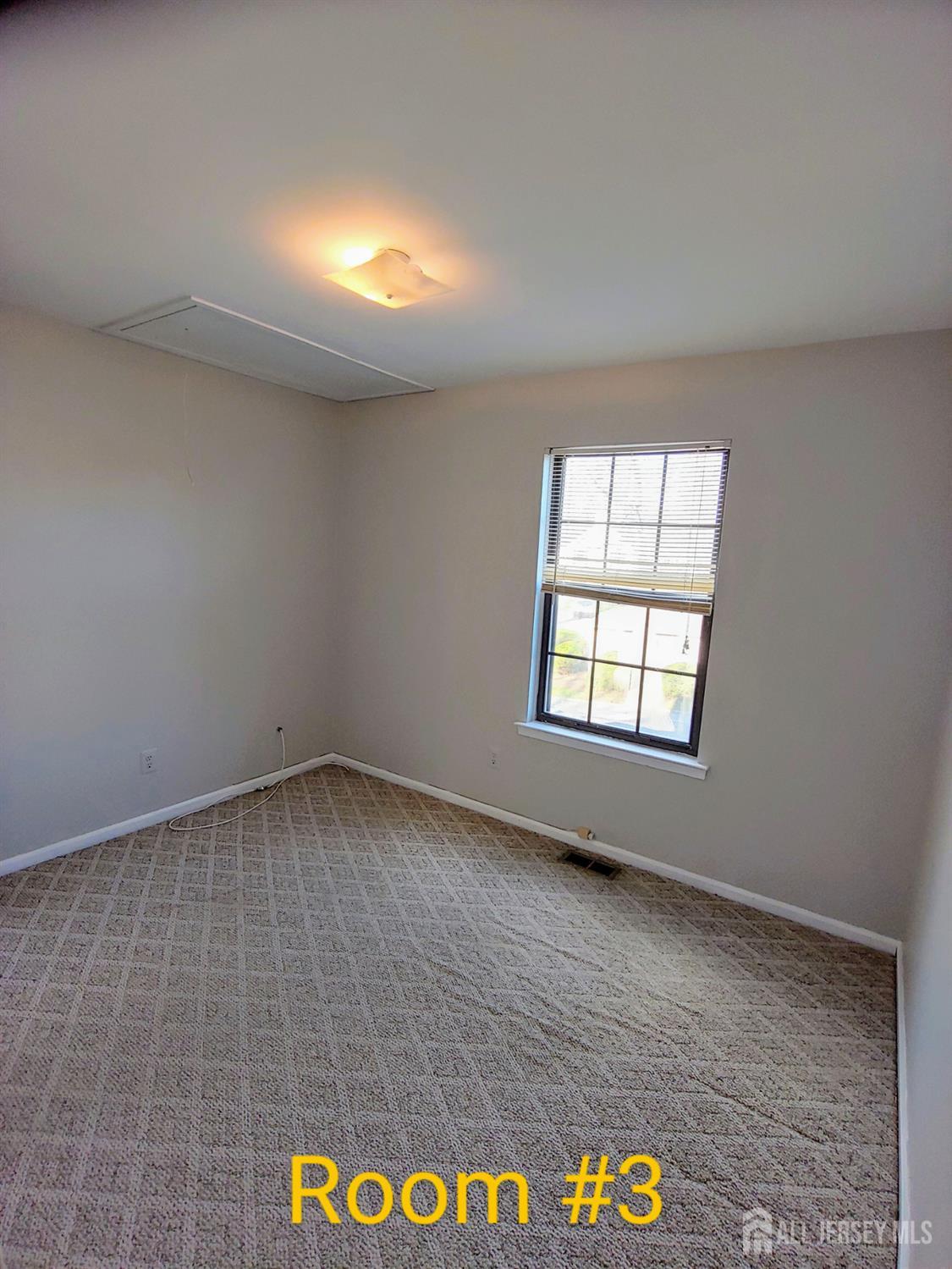 3305 Stonehedge Road Edison, NJ 08820 - Photo 16 of 16 an empty room with a empty space and window