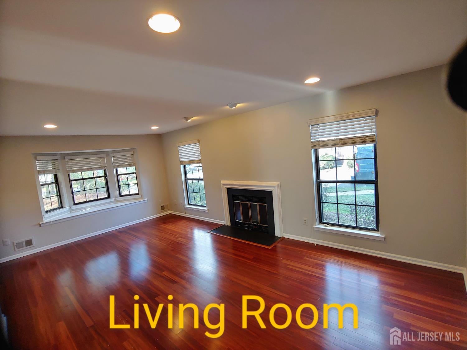 3305 Stonehedge Road Edison, NJ 08820 - Photo 2 of 16 a view of an empty room with window fireplace and wooden floor