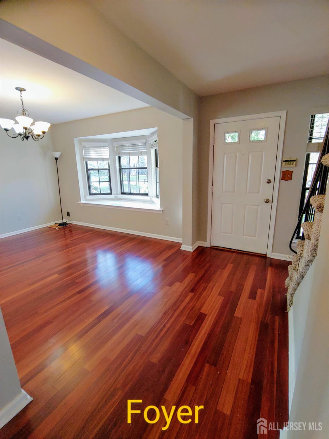 3305 Stonehedge Road Edison, NJ 08820 - Photo 6 of 16 a view of a room with wooden floor and staircase