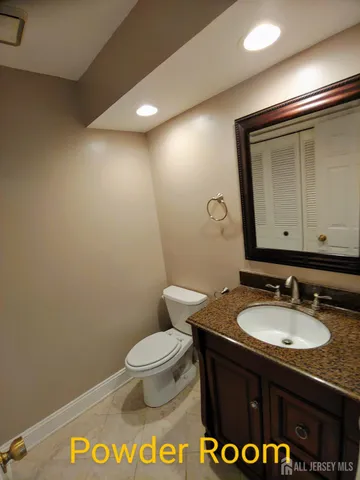 a bathroom with a sink a toilet and mirror