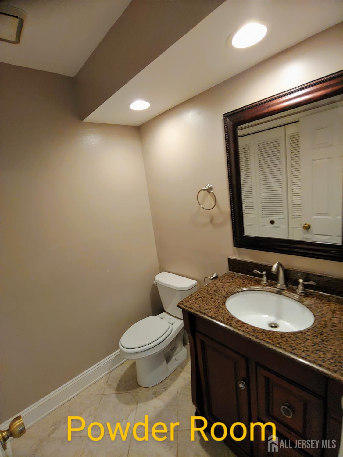 3305 Stonehedge Road Edison, NJ 08820 - Photo 8 of 16 a bathroom with a sink a toilet and mirror