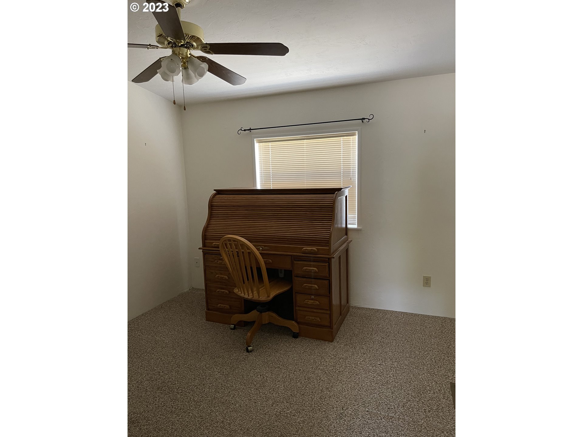 100 River Bend Road, Unit 121 Reedsport, OR 97467 - Photo 13 of 22 a room with a chair and a ceiling fan