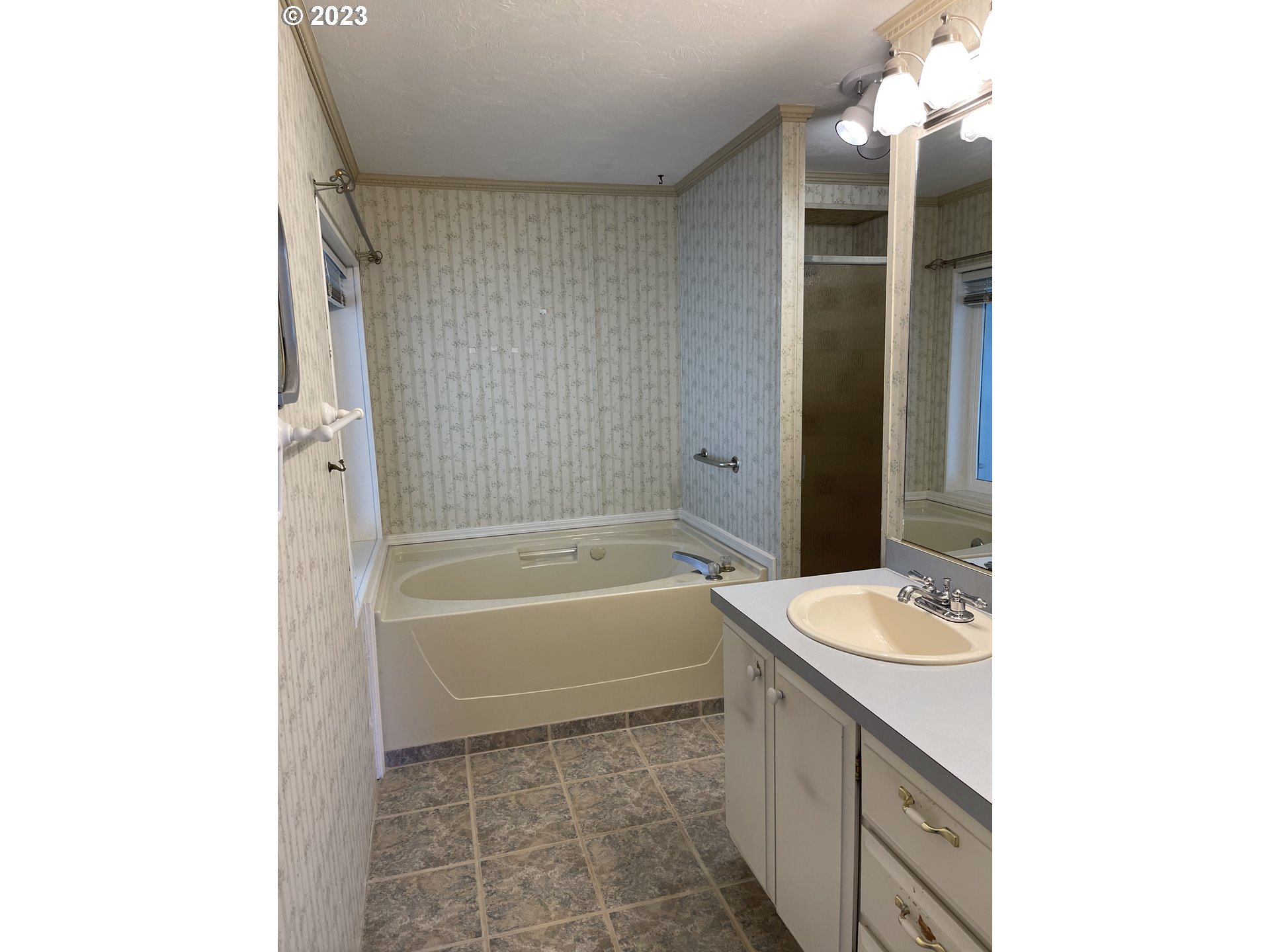 100 River Bend Road, Unit 121 Reedsport, OR 97467 - Photo 19 of 22 a bathroom with a tub sink and a mirror