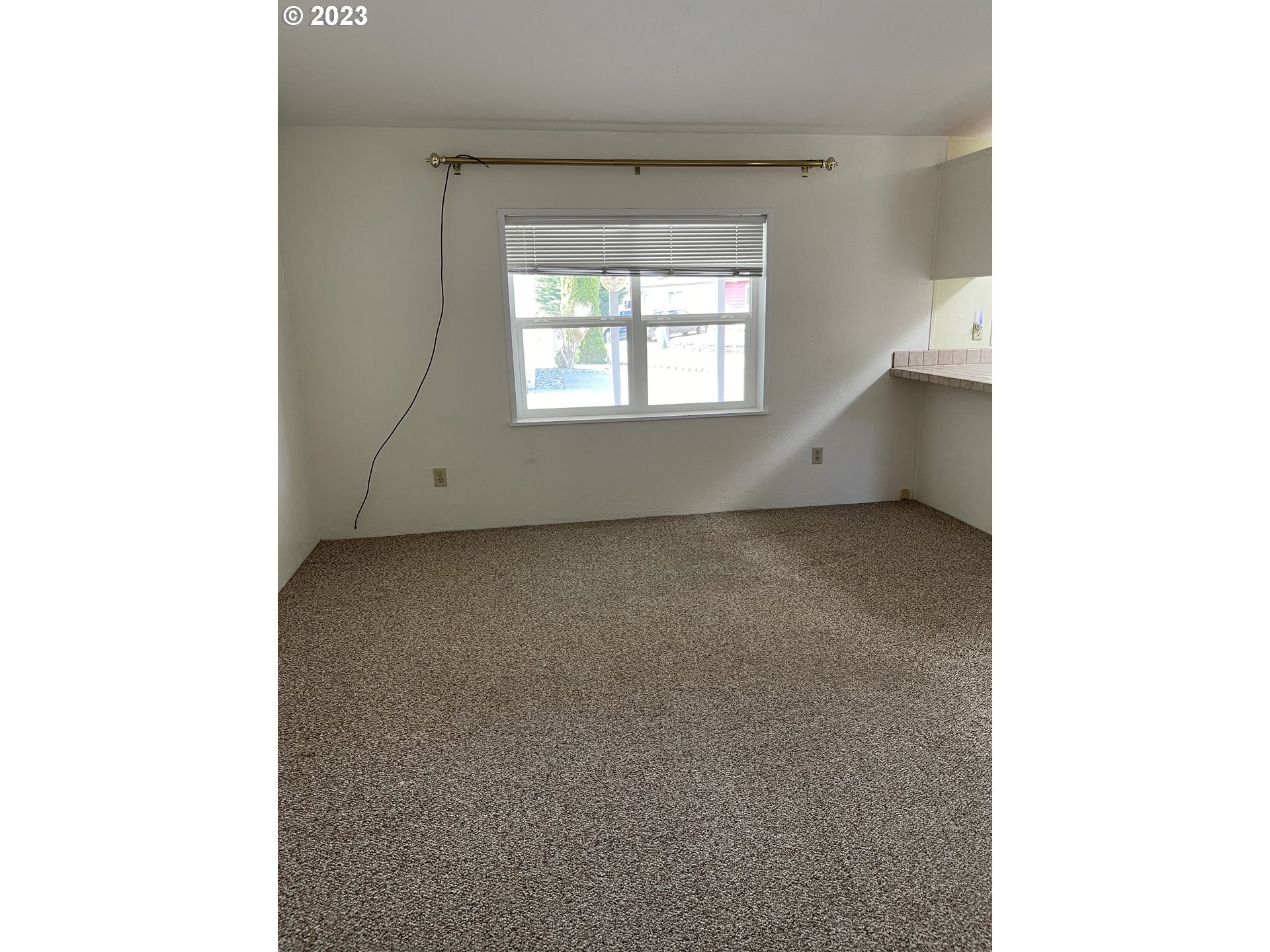 100 River Bend Road, Unit 121 Reedsport, OR 97467 - Photo 6 of 22 a view of an empty room with a window