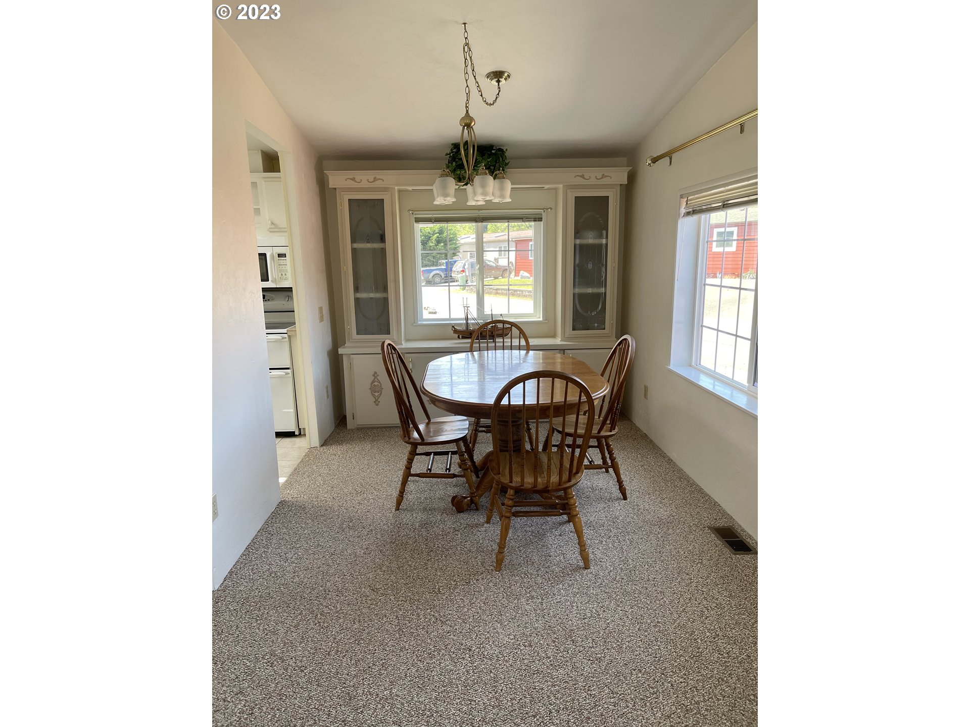 100 River Bend Road, Unit 121 Reedsport, OR 97467 - Photo 7 of 22 a view of a dining room with furniture and window