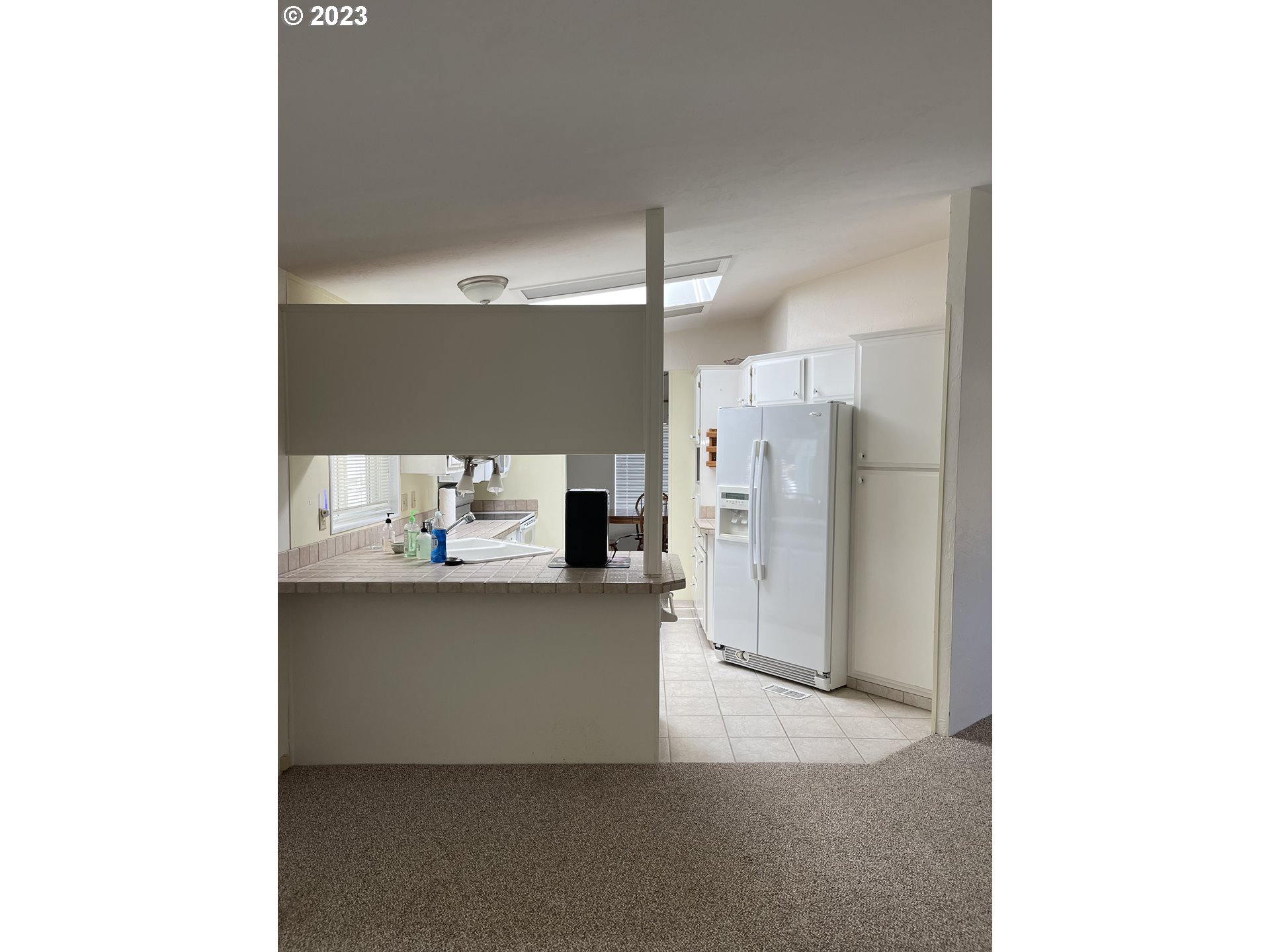 100 River Bend Road, Unit 121 Reedsport, OR 97467 - Photo 8 of 22 a kitchen with stainless steel appliances kitchen island a refrigerator sink and stove