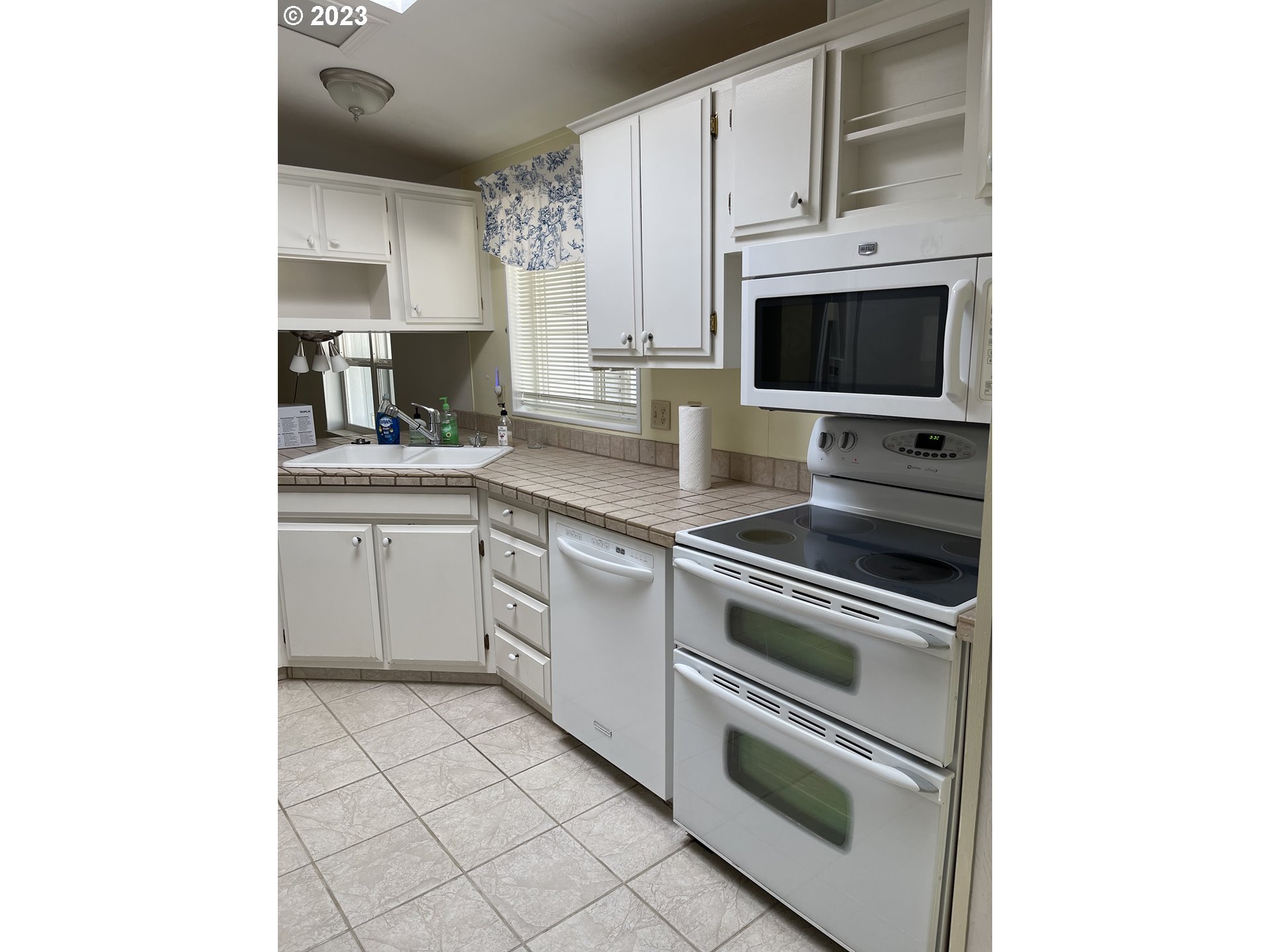 100 River Bend Road, Unit 121 Reedsport, OR 97467 - Photo 9 of 22 a kitchen with cabinets stainless steel appliances and a sink