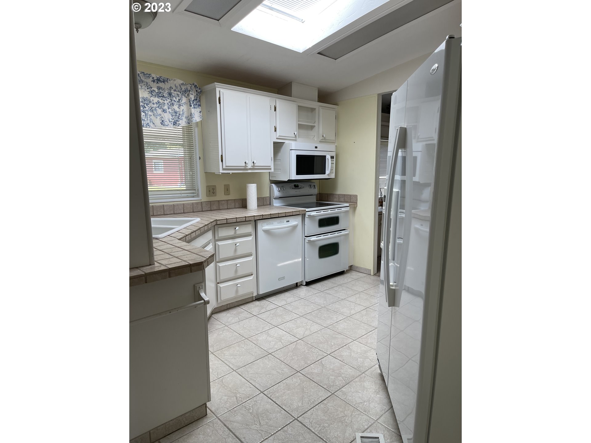100 River Bend Road, Unit 121 Reedsport, OR 97467 - Photo 10 of 22 a kitchen with stainless steel appliances a sink and a refrigerator