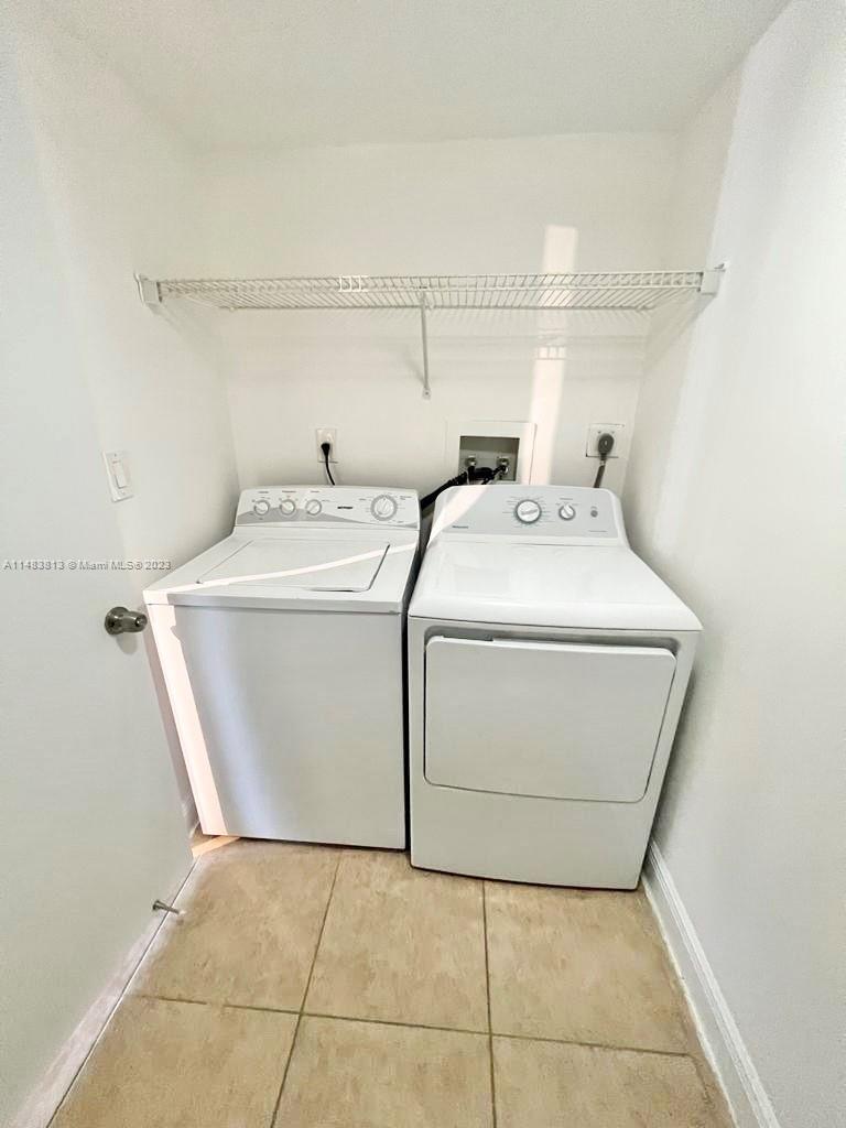 5612 Rock Island Road, Unit 141 Tamarac, FL 33319 - Photo 15 of 22 a utility room with dryer and washer