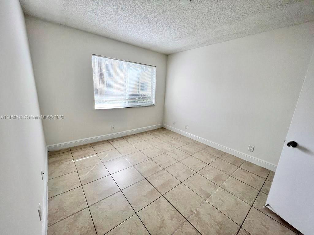 5612 Rock Island Road, Unit 141 Tamarac, FL 33319 - Photo 17 of 22 a view of an empty room and a window