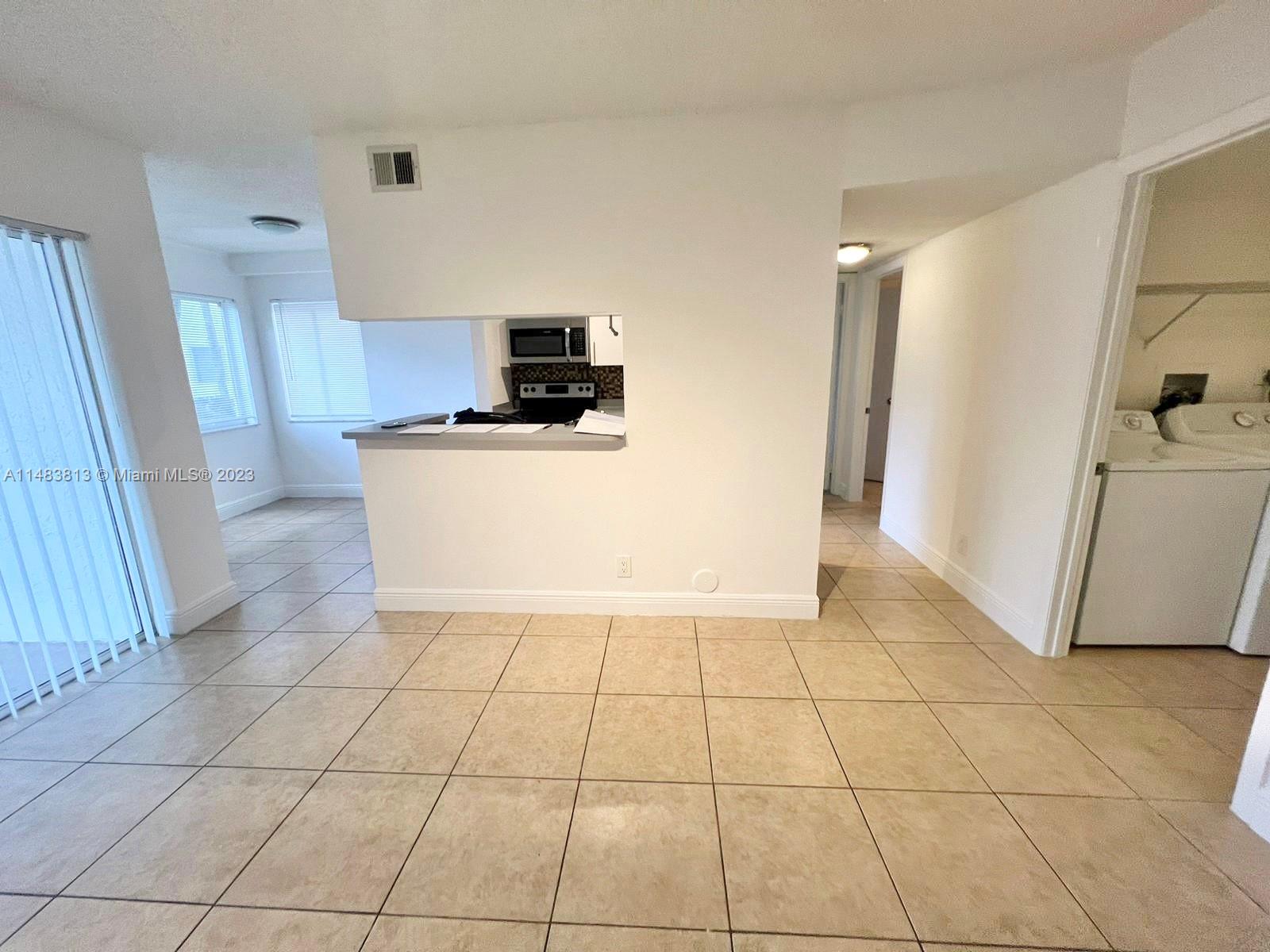 5612 Rock Island Road, Unit 141 Tamarac, FL 33319 - Photo 2 of 22 a view of a kitchen with electric appliances