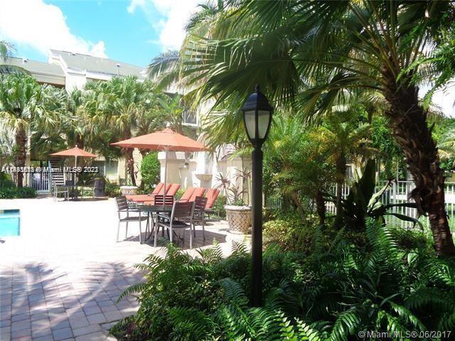 5612 Rock Island Road, Unit 141 Tamarac, FL 33319 - Photo 22 of 22 a patio with table and chairs