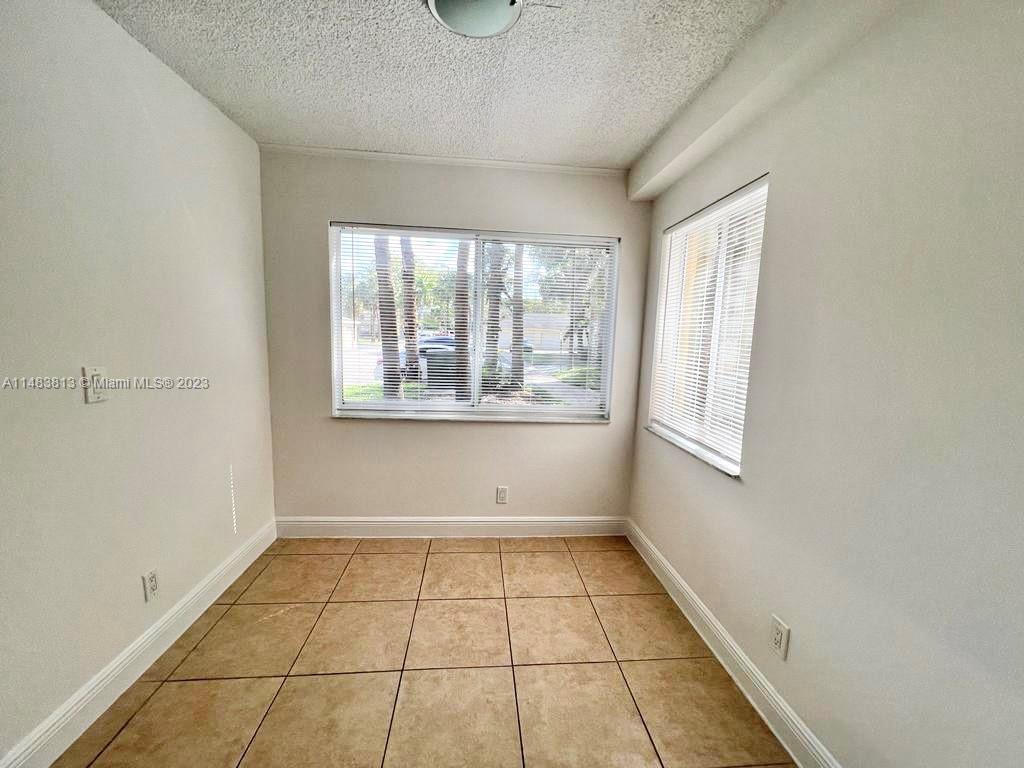 5612 Rock Island Road, Unit 141 Tamarac, FL 33319 - Photo 5 of 22 a view of empty room with windows