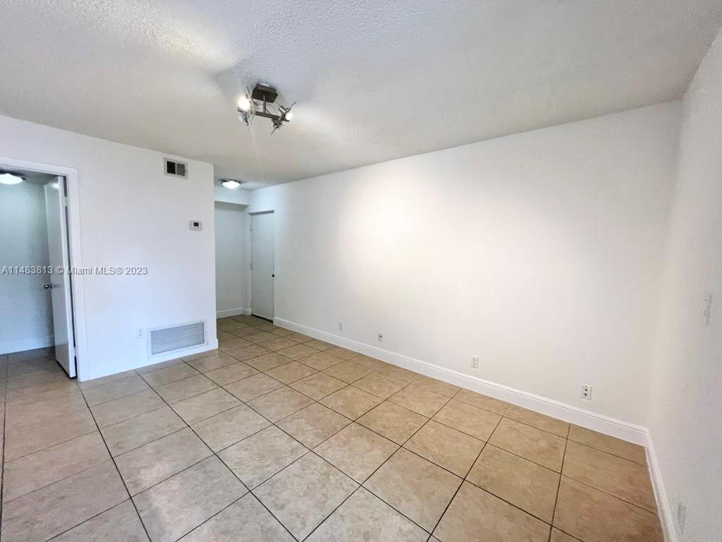 5612 Rock Island Road, Unit 141 Tamarac, FL 33319 - Photo 7 of 22 a view of a room with an empty space and a ceiling fan