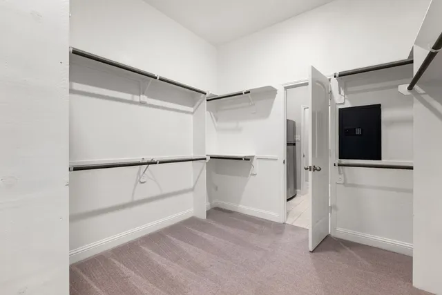 a utility room with wooden floor washer and dryer