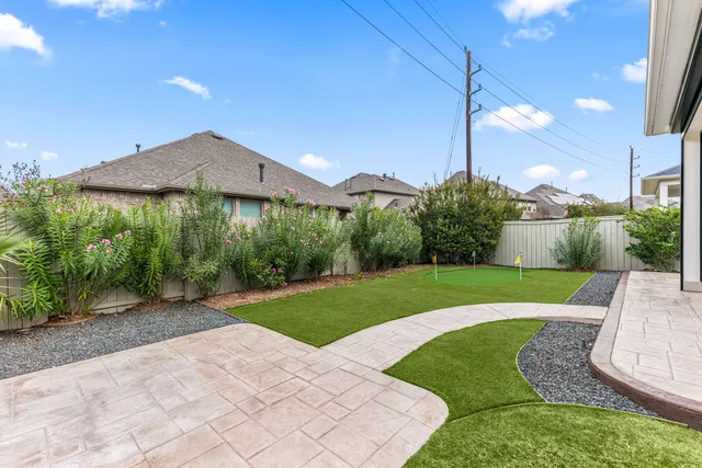 a view of a backyard with plants and a slide