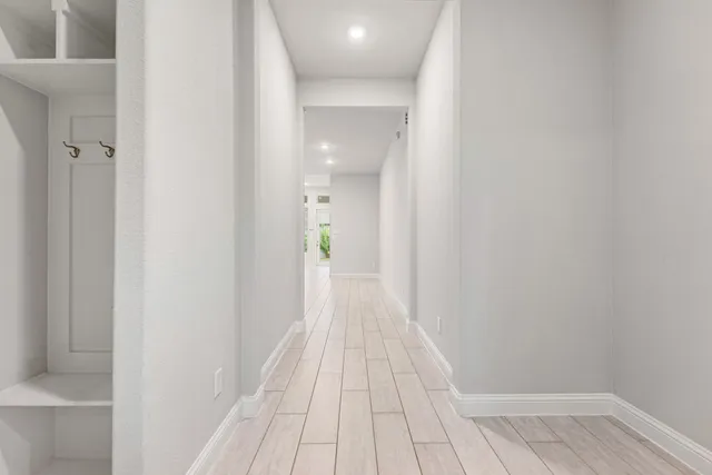 a view of a hallway with wooden floor