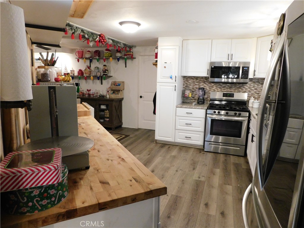 10350 Baseline, Unit 55 Alta Loma, CA 91701 - Photo 15 of 53 a kitchen with stainless steel appliances granite countertop a refrigerator a stove top oven a sink and dishwasher