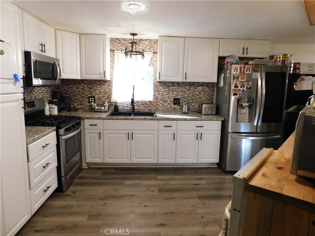 10350 Baseline, Unit 55 Alta Loma, CA 91701 - Photo 16 of 53 a kitchen with a sink white cabinets and stainless steel appliances