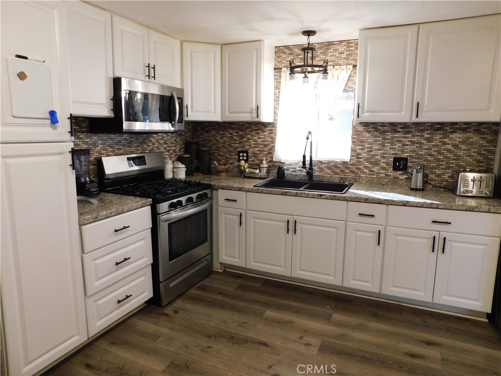 10350 Baseline, Unit 55 Alta Loma, CA 91701 - Photo 17 of 53 a kitchen with appliances a sink and cabinets