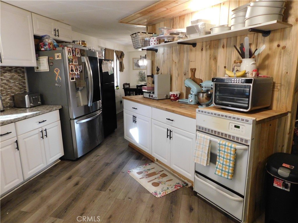 10350 Baseline, Unit 55 Alta Loma, CA 91701 - Photo 18 of 53 a kitchen with stainless steel appliances a refrigerator a stove and a sink
