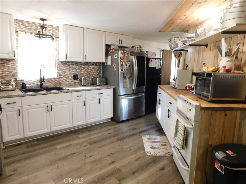 10350 Baseline, Unit 55 Alta Loma, CA 91701 - Photo 19 of 53 a kitchen with white cabinets and stainless steel appliances