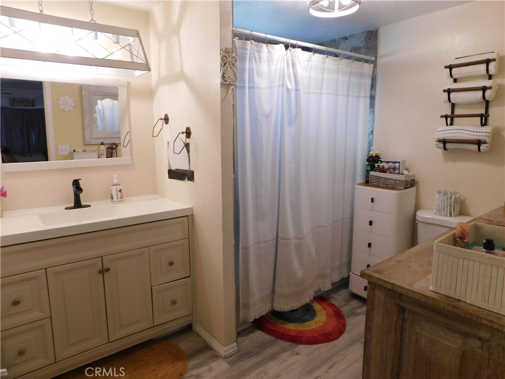 10350 Baseline, Unit 55 Alta Loma, CA 91701 - Photo 30 of 53 a bathroom with a sink a toilet and shower curtain